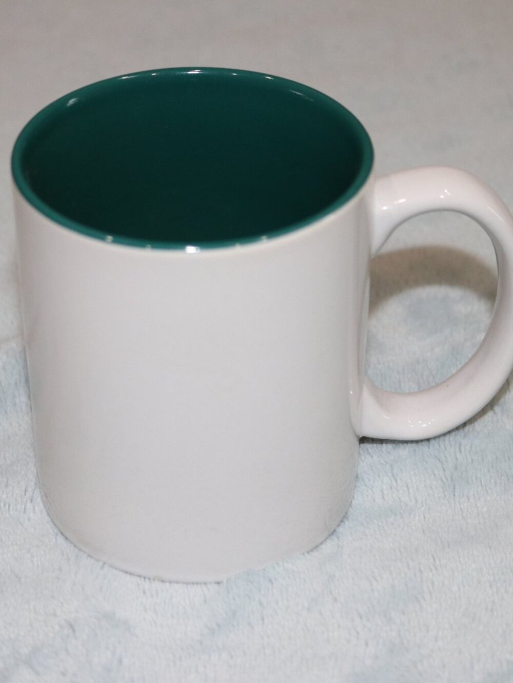 White and green coffee mug.